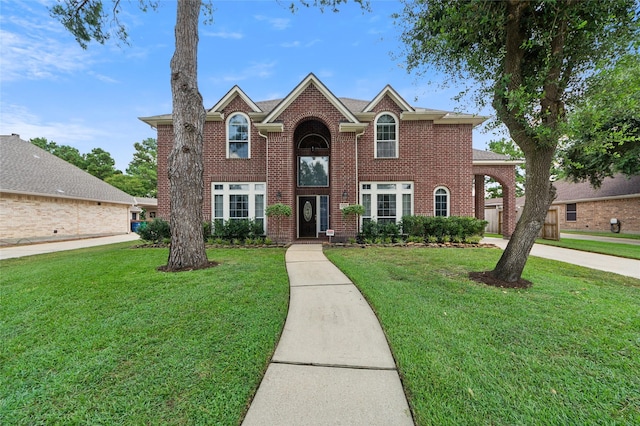 10906 Silverado Trace Dr, Houston, TX 77095 - traditional home featuring brick siding, a front yard, and driveway