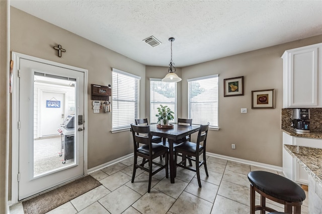10906 Silverado Trace Dr, Houston, TX 77095 - dining area with plenty of natural light, light tile patterned floors, and a textured ceiling