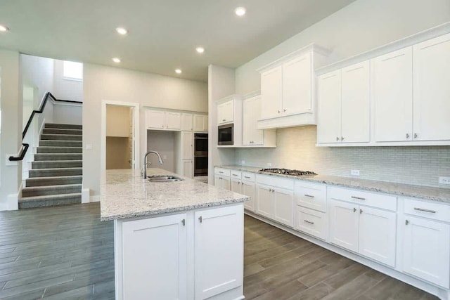 29838 Beth Ter, Fulshear, TX 77441 - kitchen with stainless steel appliances, dark wood-type flooring, white cabinetry, decorative backsplash, and recessed lighting