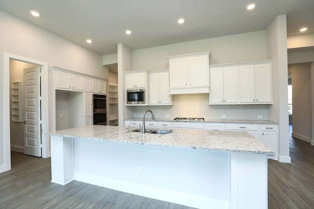 29838 Beth Ter, Fulshear, TX 77441 - kitchen with stainless steel appliances, white cabinetry, dark wood finished floors, and recessed lighting