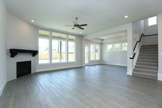 29838 Beth Ter, Fulshear, TX 77441 - unfurnished living room with a ceiling fan, plenty of natural light, wood finished floors, stairs, and recessed lighting
