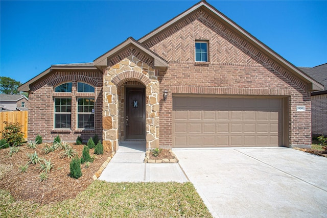 2926 Grand Hawthorne Rd, Conroe, TX 77385 - view of front facade with brick siding, driveway, and an attached garage