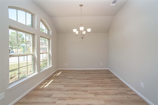 2926 Grand Hawthorne Rd, Conroe, TX 77385 - spare room featuring a chandelier, light wood finished floors, and vaulted ceiling