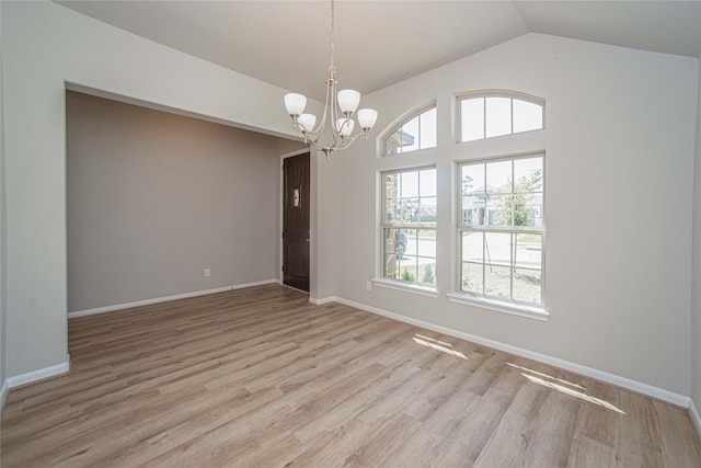 2926 Grand Hawthorne Rd, Conroe, TX 77385 - empty room with a chandelier, vaulted ceiling, and light wood-style flooring