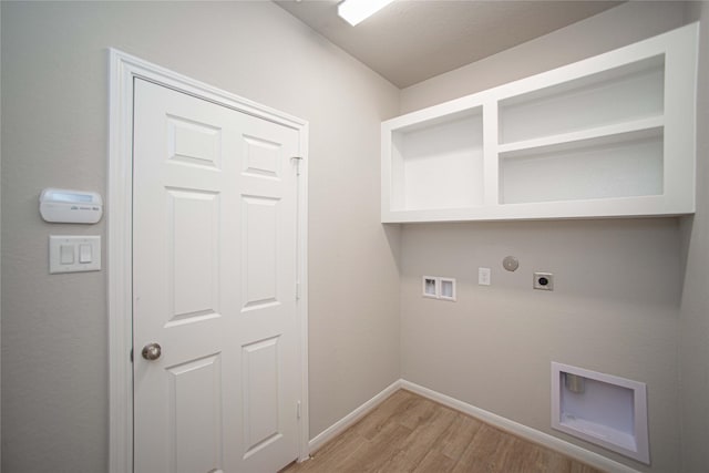 2926 Grand Hawthorne Rd, Conroe, TX 77385 - laundry room featuring electric dryer hookup, light wood-style floors, hookup for a washing machine, and gas dryer hookup