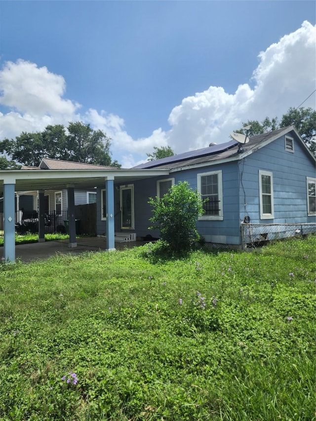 4802 Hain St, Houston, TX 77009 - back of house featuring roof mounted solar panels and a lawn