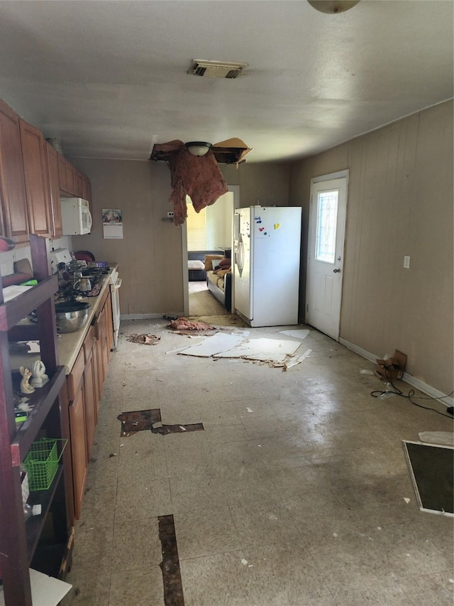 4802 Hain St, Houston, TX 77009 - kitchen with white appliances and brown cabinetry