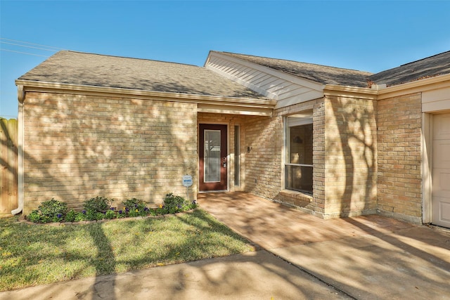 11822 Poplar Creek Dr, Houston, TX 77077 - doorway to property featuring brick siding and a shingled roof