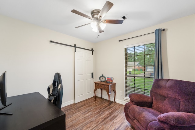 16230 Bowie Ridge Ln, Houston, TX 77053 - home office with wood finished floors, a ceiling fan, and a barn door