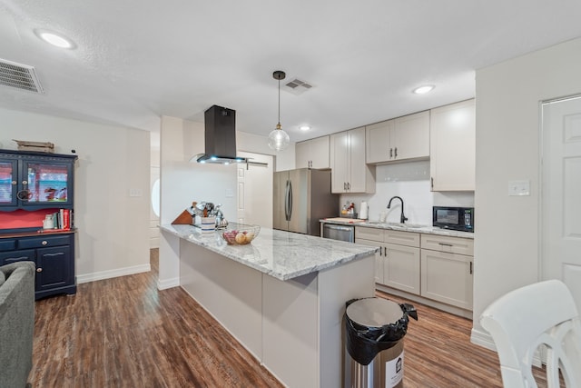 16230 Bowie Ridge Ln, Houston, TX 77053 - kitchen featuring island range hood, appliances with stainless steel finishes, dark wood-type flooring, light stone counters, and recessed lighting