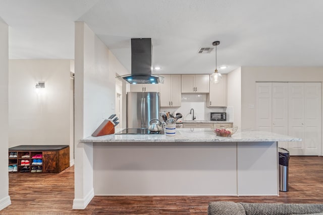 16230 Bowie Ridge Ln, Houston, TX 77053 - kitchen featuring island exhaust hood, black appliances, dark wood finished floors, light stone counters, and decorative light fixtures