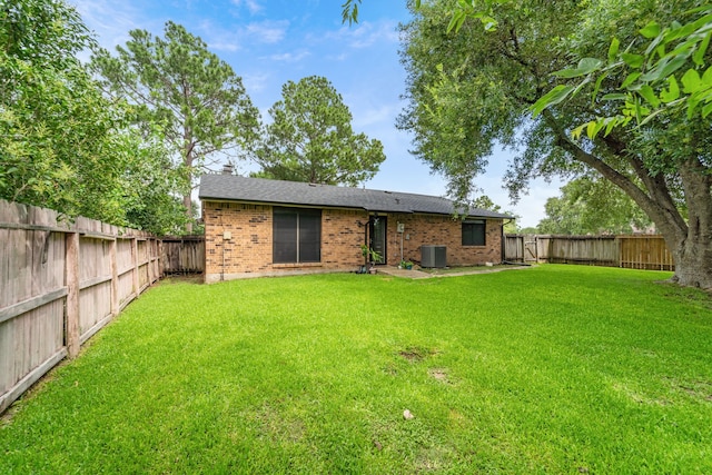 16230 Bowie Ridge Ln, Houston, TX 77053 - back of property with brick siding, a fenced backyard, and a chimney