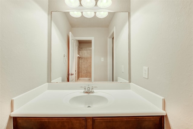 634 Oak Ridge Grove Cir, Spring, TX 77386 - bathroom featuring vanity, a textured wall, and a shower