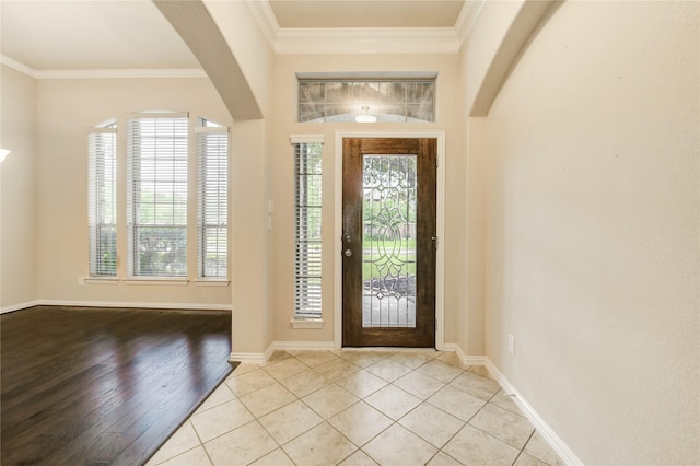 634 Oak Ridge Grove Cir, Spring, TX 77386 - foyer entrance with arched walkways, crown molding, and light tile patterned flooring