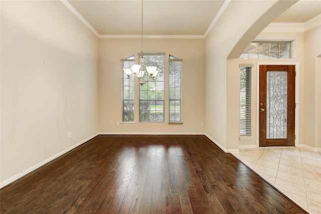 634 Oak Ridge Grove Cir, Spring, TX 77386 - foyer with a chandelier, wood finished floors, and crown molding