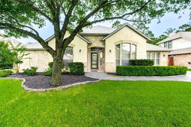 634 Oak Ridge Grove Cir, Spring, TX 77386 - french country inspired facade with a front yard and stone siding