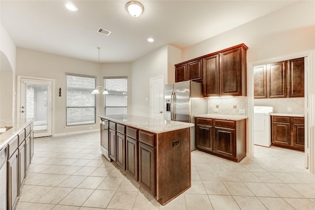 634 Oak Ridge Grove Cir, Spring, TX 77386 - kitchen featuring washer / clothes dryer, light tile patterned floors, stainless steel appliances, backsplash, and recessed lighting