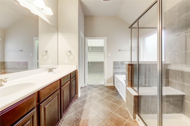 634 Oak Ridge Grove Cir, Spring, TX 77386 - full bathroom with vaulted ceiling, a garden tub, double vanity, a shower stall, and a spacious closet