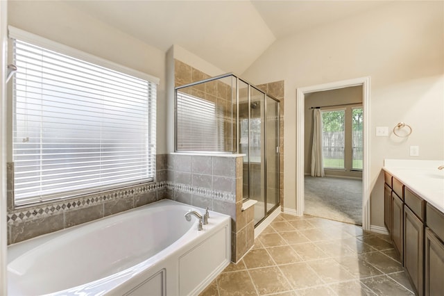 634 Oak Ridge Grove Cir, Spring, TX 77386 - full bathroom featuring a garden tub, vanity, a stall shower, and vaulted ceiling