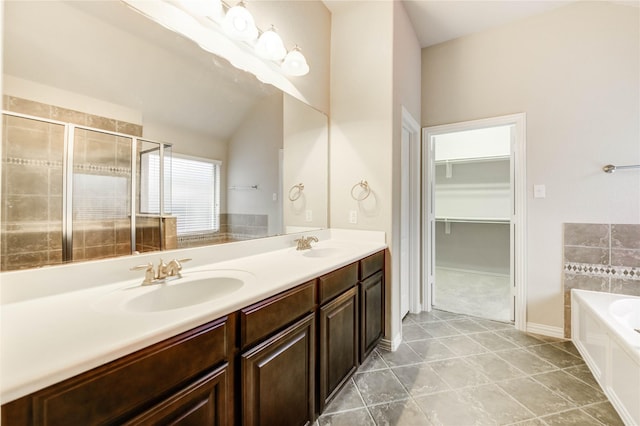 634 Oak Ridge Grove Cir, Spring, TX 77386 - full bath featuring a garden tub, double vanity, a shower stall, a walk in closet, and tile patterned floors