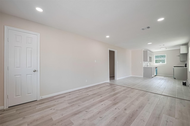 11311 Raincove Dr, Houston, TX 77016 - unfurnished living room featuring light wood-style floors and recessed lighting