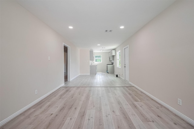 11311 Raincove Dr, Houston, TX 77016 - unfurnished living room featuring light wood-type flooring and recessed lighting