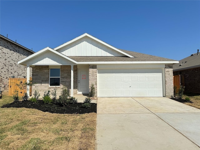 402 Emma St, Angleton, TX 77515 - ranch-style home featuring brick siding, driveway, a garage, and board and batten siding