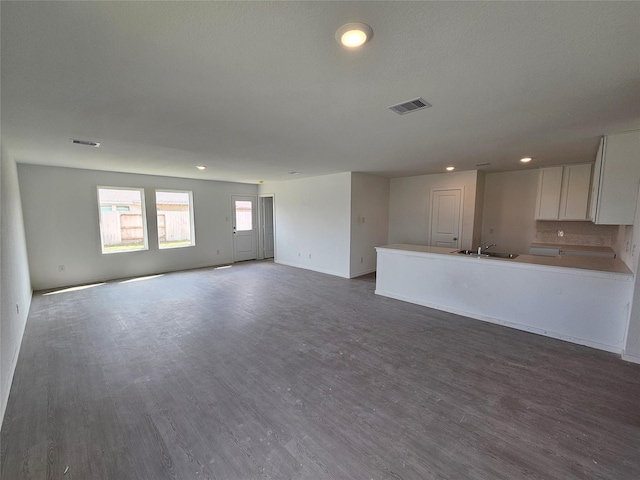402 Emma St, Angleton, TX 77515 - unfurnished living room featuring recessed lighting and dark wood-style flooring
