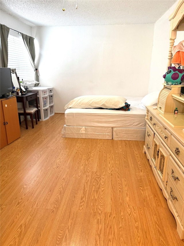 12606 Newbrook Dr, Houston, TX 77072 - bedroom with light wood-style floors and a textured ceiling