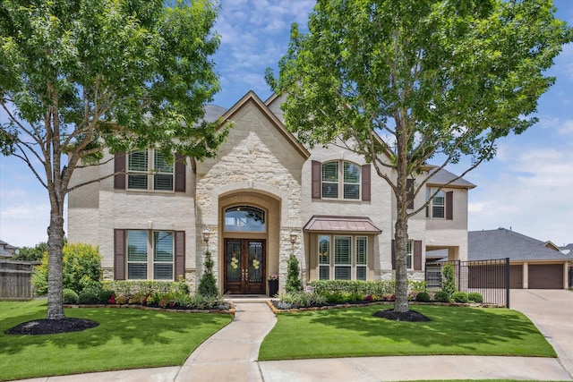 28114 Bayou Cove Ct, Fulshear, TX 77441 - french country home featuring french doors, stone siding, and driveway
