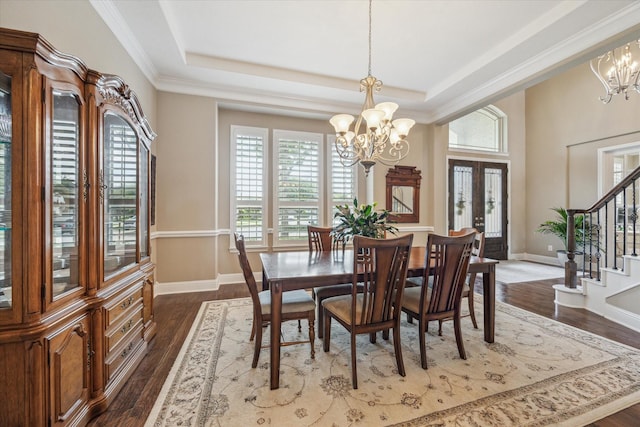 28114 Bayou Cove Ct, Fulshear, TX 77441 - dining area with a chandelier, stairs, a tray ceiling, dark wood-style floors, and ornamental molding