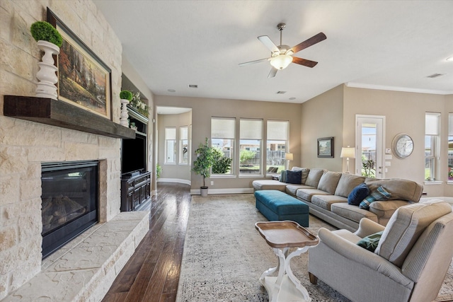 28114 Bayou Cove Ct, Fulshear, TX 77441 - living room with hardwood / wood-style floors, healthy amount of natural light, ceiling fan, a stone fireplace, and crown molding