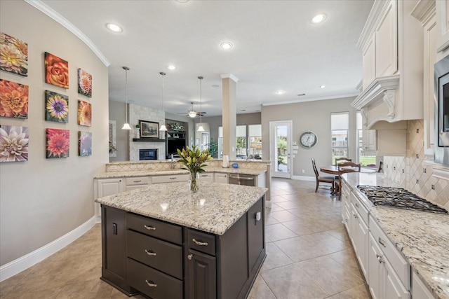 28114 Bayou Cove Ct, Fulshear, TX 77441 - kitchen with white cabinets, backsplash, stainless steel appliances, open floor plan, and ceiling fan