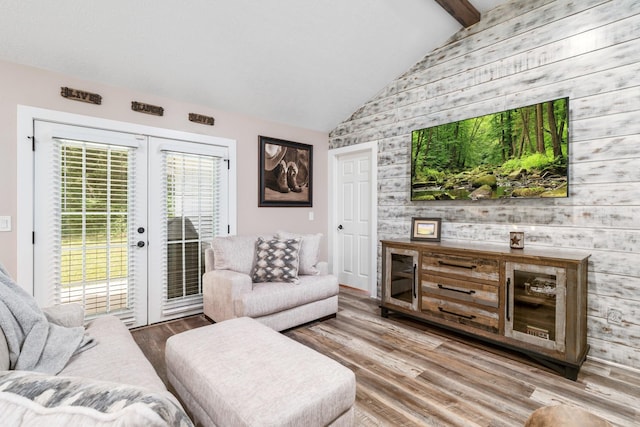 137 County Road 3665, Splendora, TX 77372 - living room featuring wooden walls, wood finished floors, french doors, and an accent wall