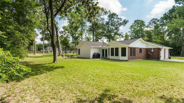 137 County Road 3665, Splendora, TX 77372 - back of property featuring brick siding, an attached garage, and driveway