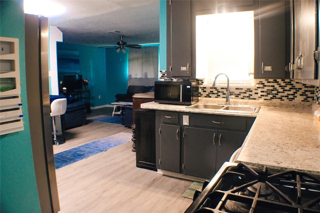 329 Robin St, Deer Park, TX 77536 - kitchen featuring black microwave, light wood finished floors, tasteful backsplash, and a ceiling fan