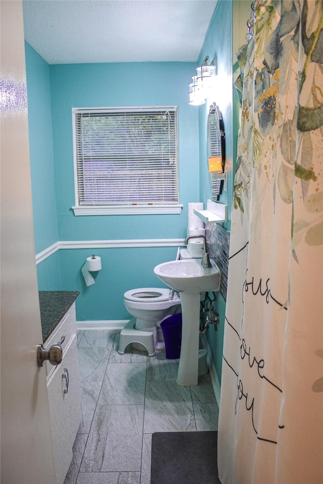 329 Robin St, Deer Park, TX 77536 - bathroom with marble look tile flooring and a textured ceiling
