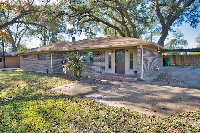 1303 Mac Dr, Sweeny, TX 77480 - view of front of property featuring brick siding, concrete driveway, and an attached carport