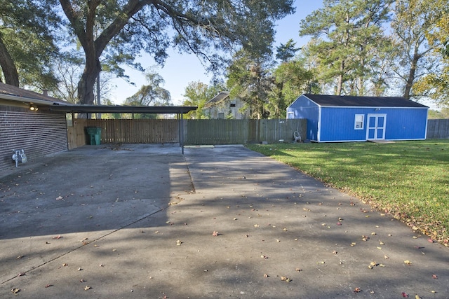 1303 Mac Dr, Sweeny, TX 77480 - view of patio featuring driveway, an outbuilding, and a carport