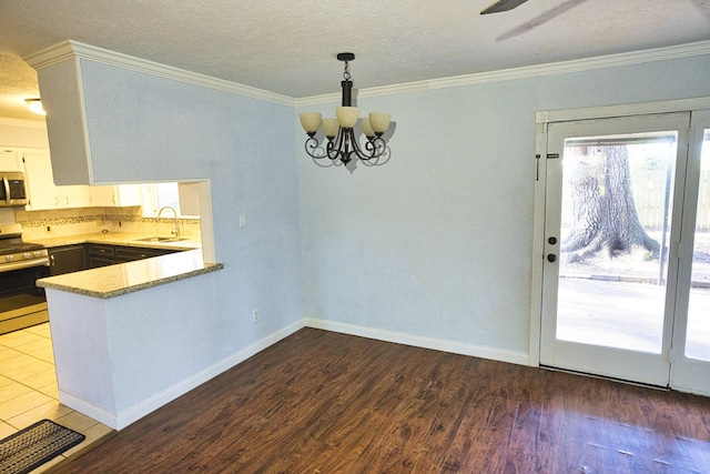 1303 Mac Dr, Sweeny, TX 77480 - unfurnished dining area with ornamental molding, a chandelier, and wood finished floors
