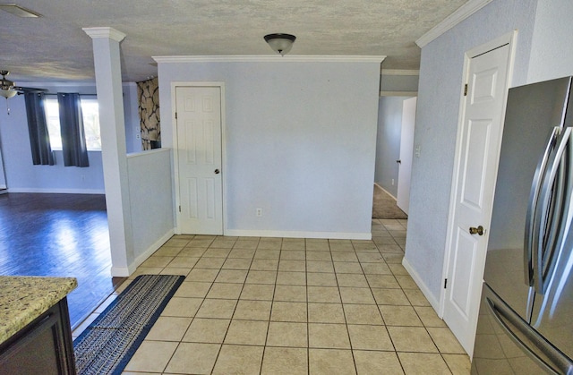 1303 Mac Dr, Sweeny, TX 77480 - unfurnished room featuring crown molding, light tile patterned floors, ceiling fan, and decorative columns
