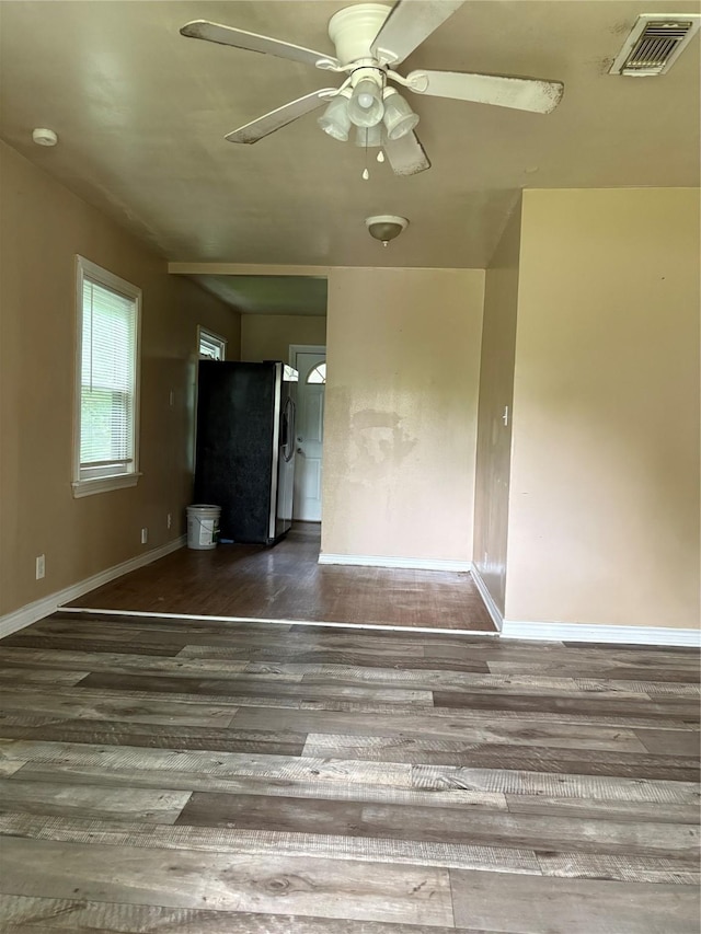 1206 11th St N, Texas City, TX 77590 - unfurnished living room with wood finished floors and ceiling fan