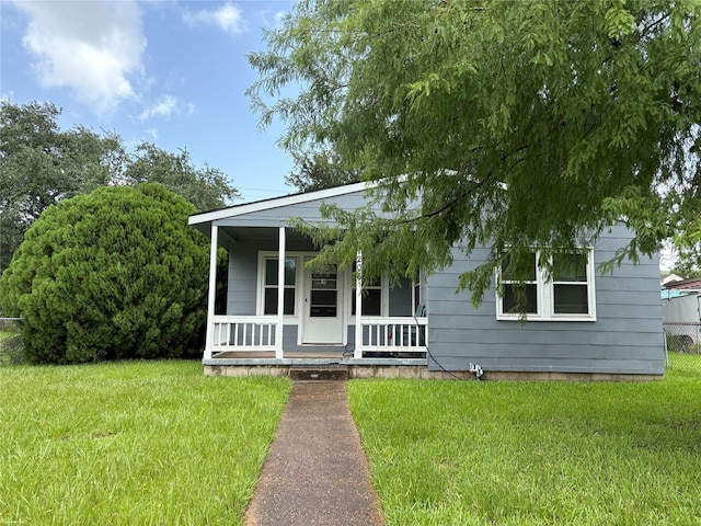 1206 11th St N, Texas City, TX 77590 - view of front of property with a porch and a front lawn