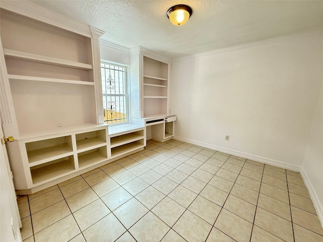 5701 Luna St, Houston, TX 77076 - interior space featuring light tile patterned floors, a textured ceiling, ornamental molding, and built in shelves