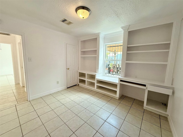 5701 Luna St, Houston, TX 77076 - unfurnished bedroom featuring light tile patterned flooring, a textured ceiling, and crown molding