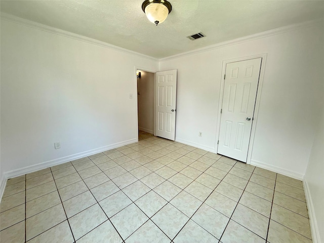 5701 Luna St, Houston, TX 77076 - spare room featuring crown molding, light tile patterned floors, and a textured ceiling