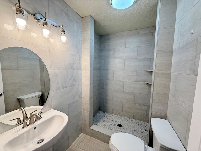 5701 Luna St, Houston, TX 77076 - full bath featuring tile walls, a tile shower, and a textured ceiling
