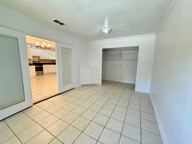 5701 Luna St, Houston, TX 77076 - unfurnished bedroom with light tile patterned floors, ornamental molding, a chandelier, a textured ceiling, and a closet