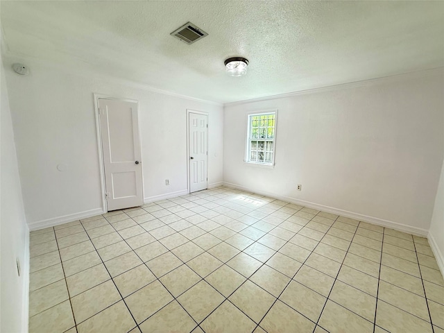 5701 Luna St, Houston, TX 77076 - empty room with ornamental molding, a textured ceiling, light tile patterned flooring, and a smoke detector