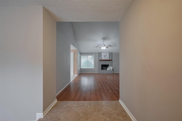 3031 The Highlands Dr, Sugar Land, TX 77478 - hallway with lofted ceiling, a textured ceiling, and light tile patterned floors